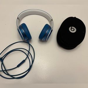 Blue wired beats headphones.